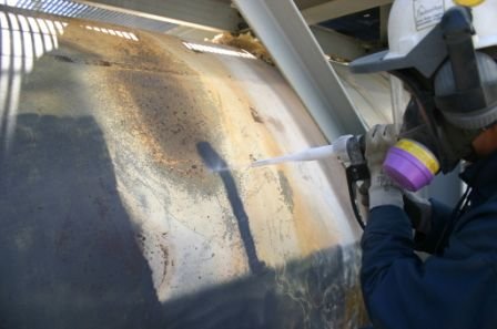 Dry ice blasting cleaning storage tank at refinery